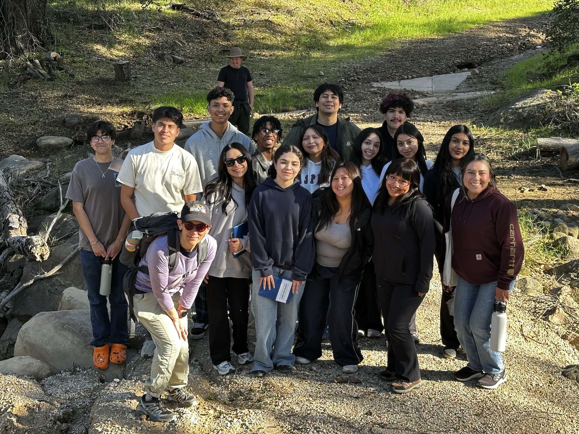 Students and staff standing together outside 