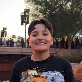Yardi EJ student with short brown hair wearing a black t-shirt with cars on it.