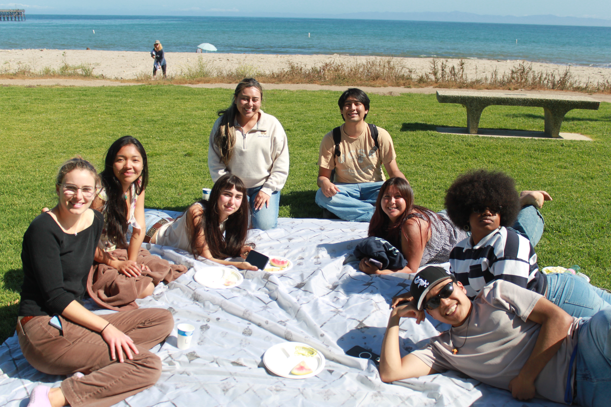 Yardi students and staff on a picnic blanket at Goleta Beach Park.